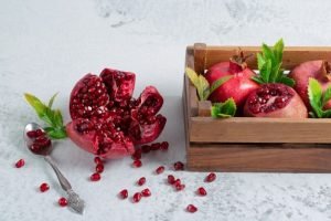 fresh-sliced-pomegranate-grey-surface-with-fruit-bow_114579-82965.jpg